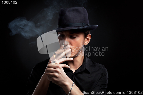 Image of Gangster look. Man with hat and cigar.