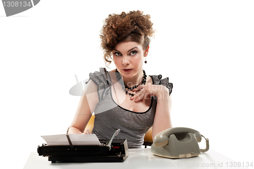 Image of Businesswoman taking telephone call in office