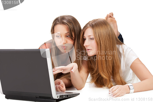 Image of two young happy student girl work on laptop