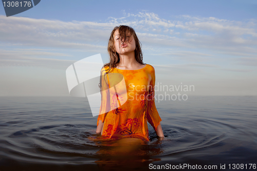 Image of girl posing in the Water at sunset