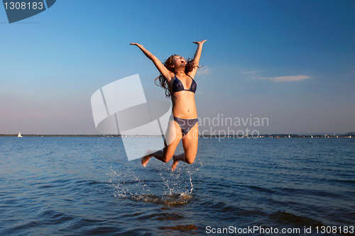 Image of young woman on the sky and water background