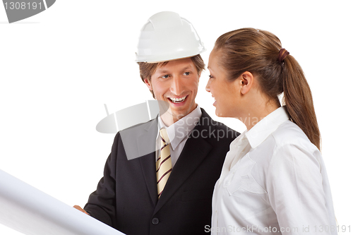 Image of An architect wearing a hard hat and co-worker