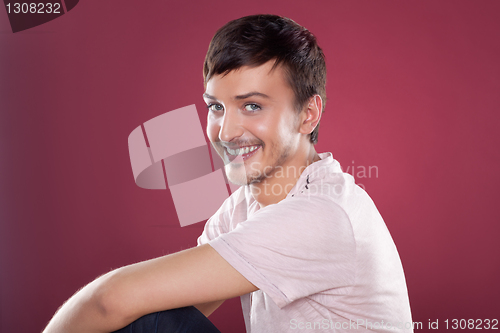 Image of Young handsome man in a white shirt over red