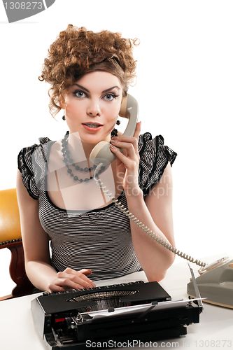 Image of Businesswoman taking telephone call in office