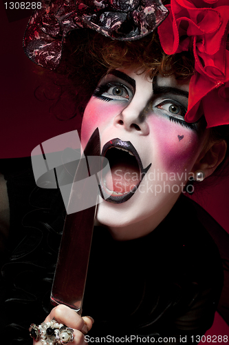 Image of woman mime with knife