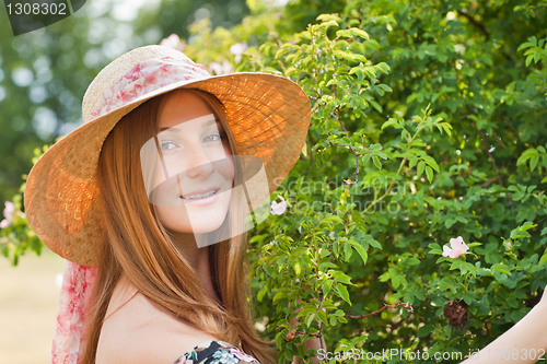 Image of Young beautiful girl with hat posing outdoor