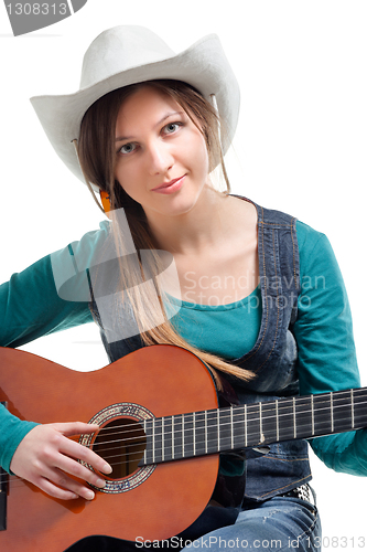 Image of cowgirl in ahat with acoustic guitar