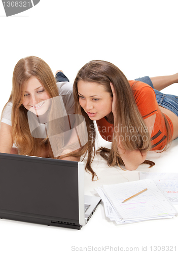 Image of two young happy student girl work on laptop