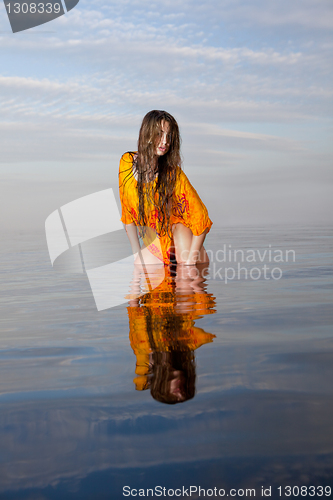 Image of girl posing in the Water at sunset