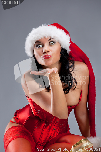 Image of Beautiful christmas woman in santa hat