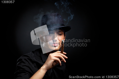 Image of Gangster look. Man with hat and cigar.