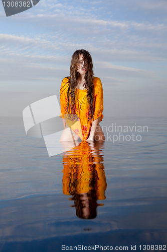 Image of girl posing in the Water at sunset