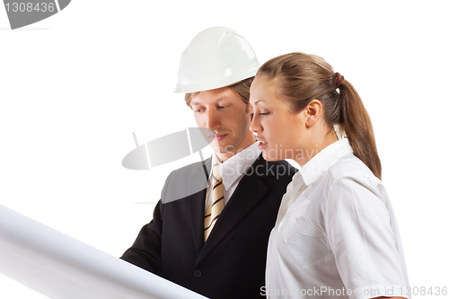 Image of An architect wearing a hard hat and co-worker