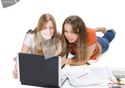 Image of two young happy student girl work on laptop