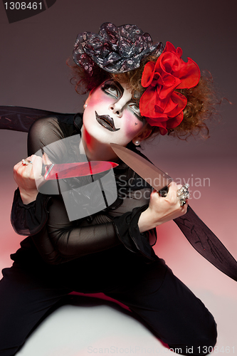 Image of woman mime with knife