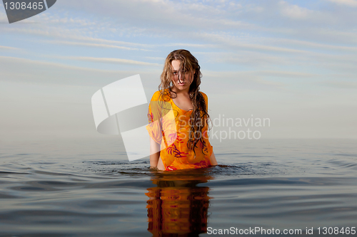 Image of girl posing in the Water at sunset