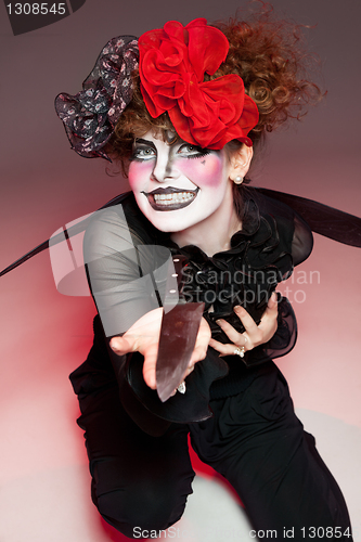 Image of woman mime with knife