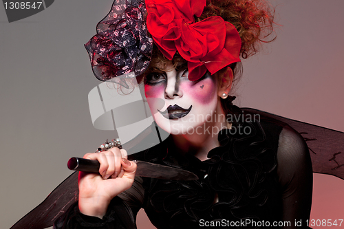 Image of woman mime with knife