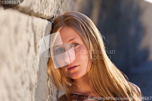 Image of Young woman outdoors at sunset