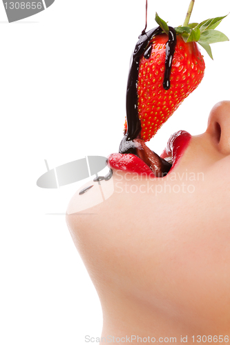 Image of girl eating strawberry with chocolate sauc