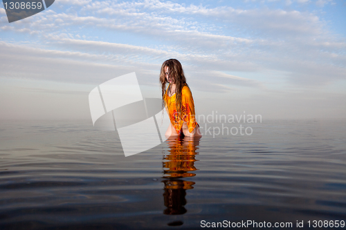 Image of girl posing in the Water at sunset