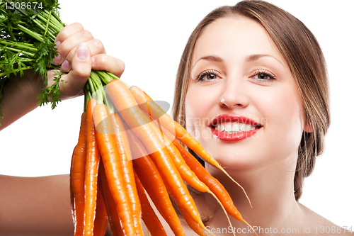 Image of attractive woman holds bunch of carrots