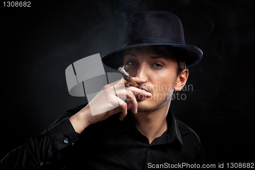 Image of Gangster look. Man with hat and cigar.