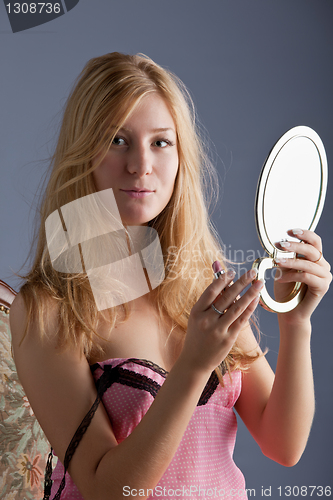 Image of beautiful woman with mirror