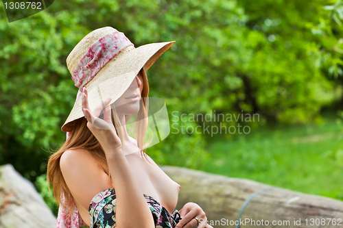 Image of Young beautiful girl with hat posing outdoor