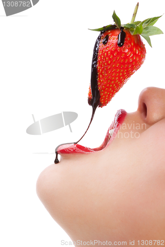 Image of girl eating strawberry with chocolate sauc