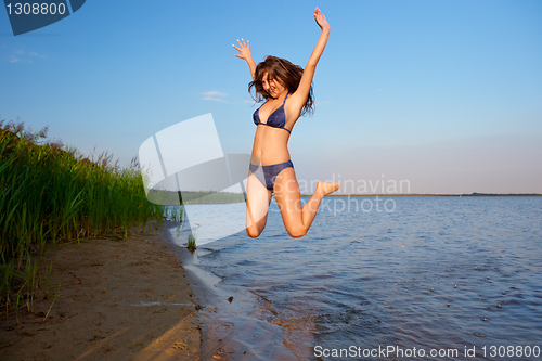 Image of young woman on the sky and water background