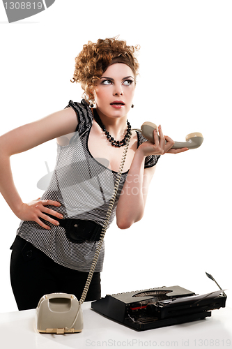 Image of Businesswoman taking telephone call in office