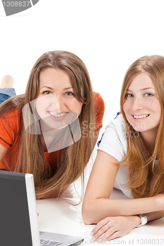 Image of two young happy student girl work on laptop