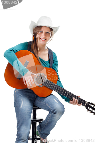 Image of cowgirl in ahat with acoustic guitar