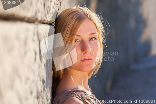 Image of Young woman outdoors at sunset