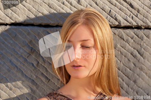 Image of Young woman outdoors at sunset