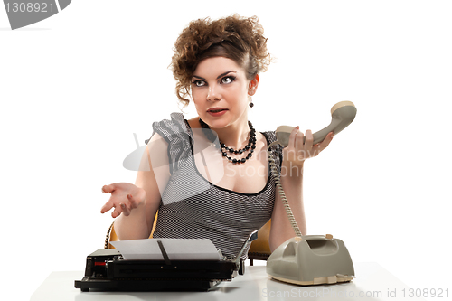 Image of Businesswoman taking telephone call in office