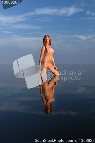 Image of girl posing in the Water at sunset,