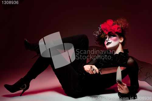 Image of woman mime with knife