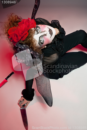 Image of woman mime with knife