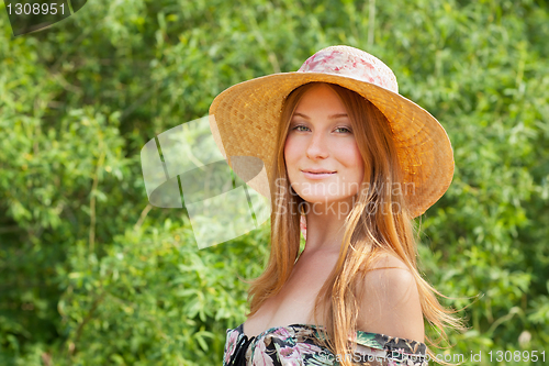 Image of Young beautiful girl with hat posing outdoor