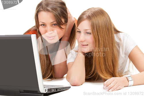 Image of two young happy student girl work on laptop