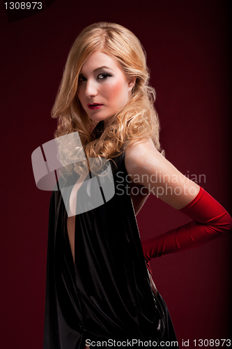 Image of Perfect blonde in a black dress on red