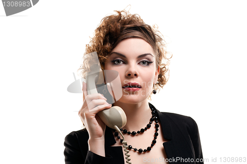 Image of Businesswoman taking telephone call in office