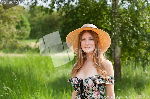 Image of Young beautiful girl with hat posing outdoor