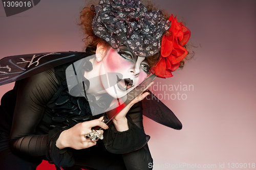 Image of woman mime with knife