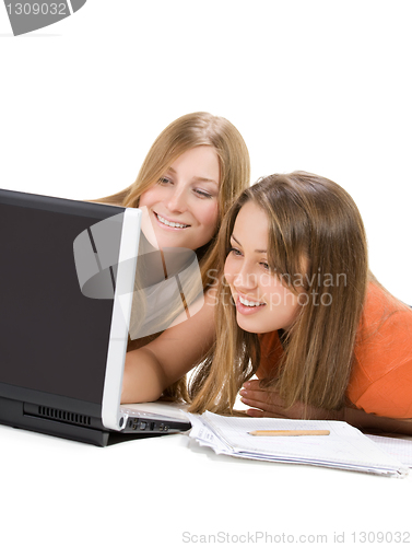 Image of two young happy student girl work on laptop