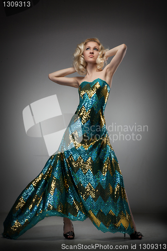 Image of Beautiful young woman in long dress