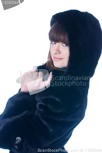 Image of Young woman in fur coat