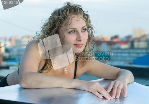 Image of Young woman on roof